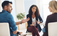 woman mediates an argument between two other people