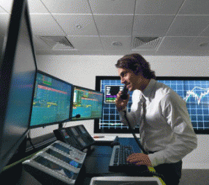 Financial trader with screens
