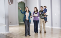 Young family with real estate agent at an open house.