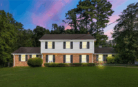 The exterior of the 2-story brick and white-siding "Wheeler House" featured in Stranger Things.
