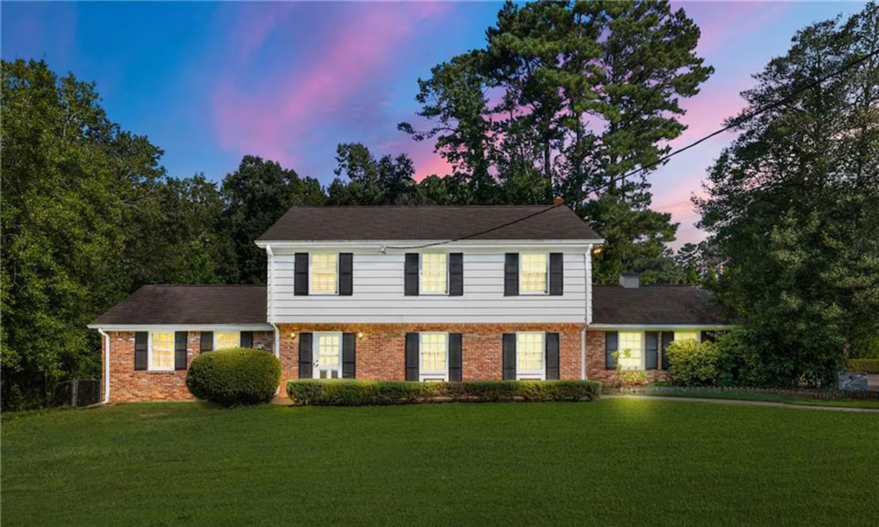 The exterior of the 2-story brick and white-siding "Wheeler House" featured in Stranger Things.