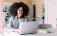 apartment seeker looks at a laptop